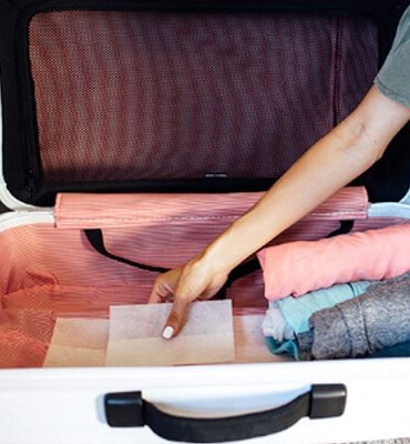 Putting dryer sheets on your luggage